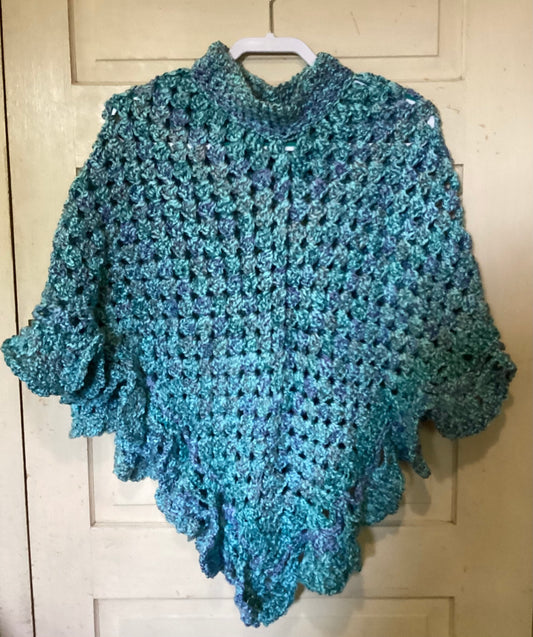 Crocheted poncho in shades of blue.
